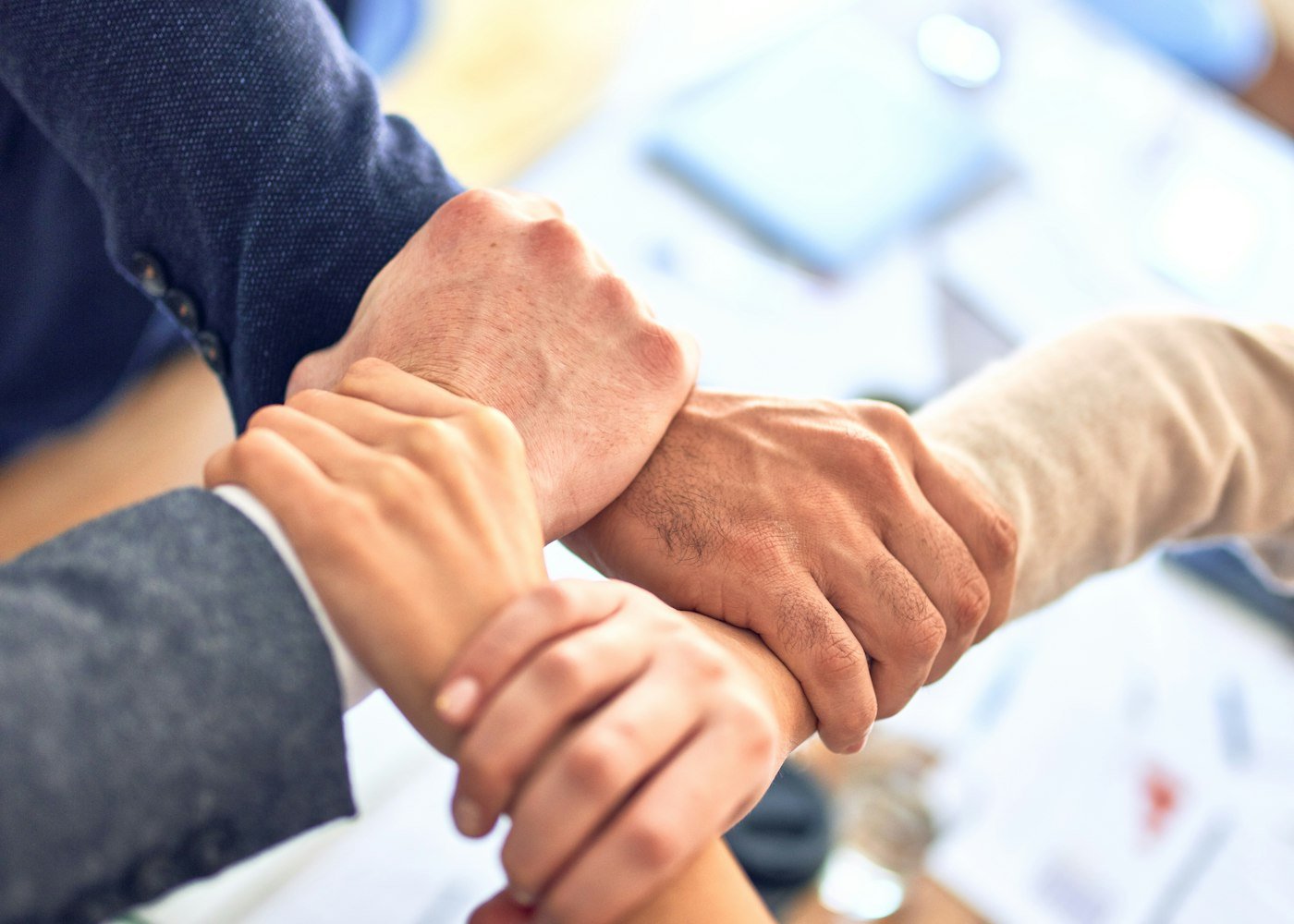 Consultant and clients joining hands in partnership