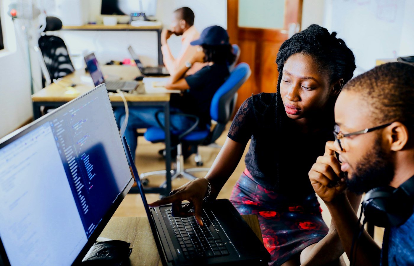 Counsellor and client reviewing an application on a laptop